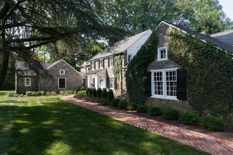 Inspiration for a country two-storey exterior in Philadelphia with stone veneer.