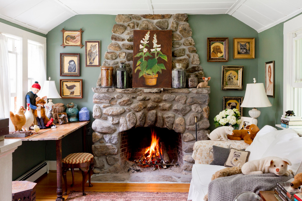 Design ideas for a small country enclosed living room in New York with green walls, medium hardwood floors, a standard fireplace and a stone fireplace surround.