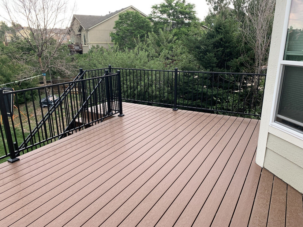 Mid-sized backyard second story metal railing deck photo with no cover