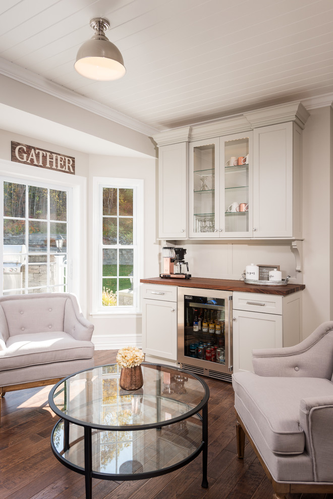 Eat-in kitchen - mid-sized transitional galley medium tone wood floor and brown floor eat-in kitchen idea with a farmhouse sink, shaker cabinets, white cabinets, quartz countertops, white backsplash, ceramic backsplash, stainless steel appliances and no island