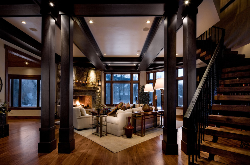 This is an example of a traditional living room in Salt Lake City with a standard fireplace and a stone fireplace surround.