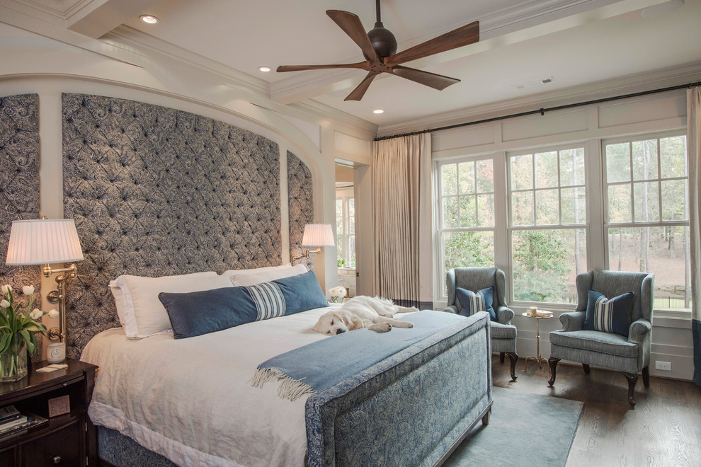 Expansive traditional bedroom in Atlanta with white walls, dark hardwood floors and brown floor.