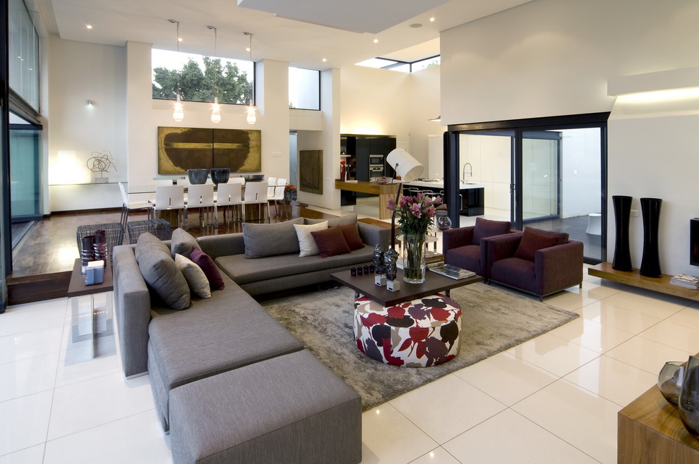 Expansive contemporary open concept living room with white floor.