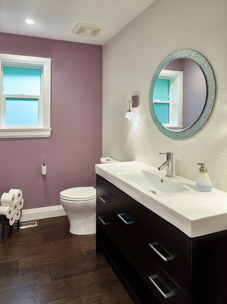 Design ideas for a mid-sized transitional 3/4 bathroom in Vancouver with flat-panel cabinets, brown cabinets, a two-piece toilet, beige tile, ceramic tile, purple walls, dark hardwood floors, a trough sink, brown floor and white benchtops.