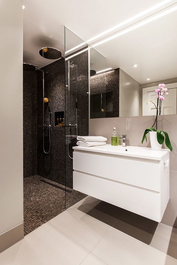 This is an example of a mid-sized modern 3/4 bathroom in Miami with flat-panel cabinets, white cabinets, an alcove shower, white tile, mosaic tile, white walls, an open shower and an integrated sink.