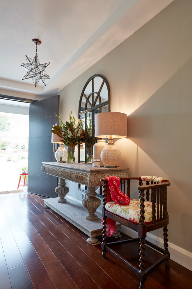 Mid-sized contemporary front door in Sydney with dark hardwood floors and a gray front door.