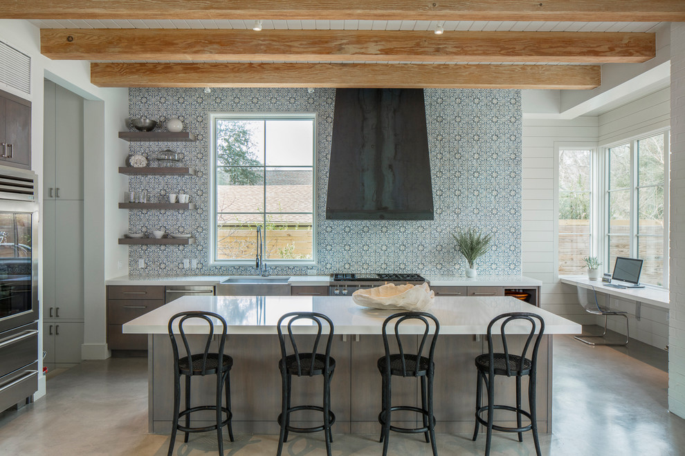Transitional concrete floor kitchen photo in Austin with a farmhouse sink, open cabinets, multicolored backsplash, stainless steel appliances and an island