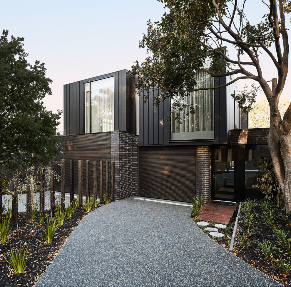 Design ideas for a contemporary two-storey black house exterior in Melbourne with mixed siding and a flat roof.