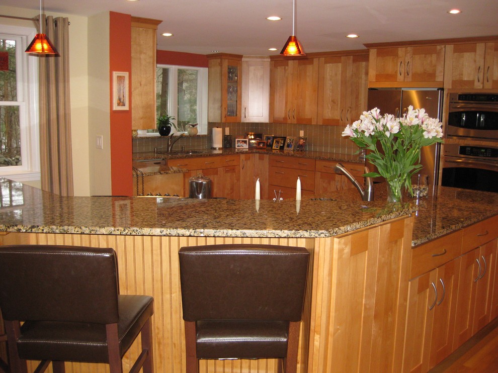 Eat-in kitchen - transitional u-shaped medium tone wood floor eat-in kitchen idea in Boston with an undermount sink, shaker cabinets, light wood cabinets, granite countertops, beige backsplash, glass tile backsplash, stainless steel appliances and an island