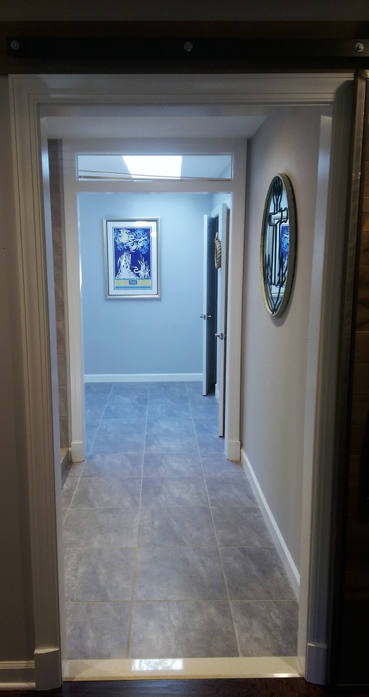 Double shower - large transitional master gray tile and porcelain tile porcelain tile and gray floor double shower idea in Baltimore with furniture-like cabinets, medium tone wood cabinets, gray walls, an undermount sink, marble countertops and a hinged shower door