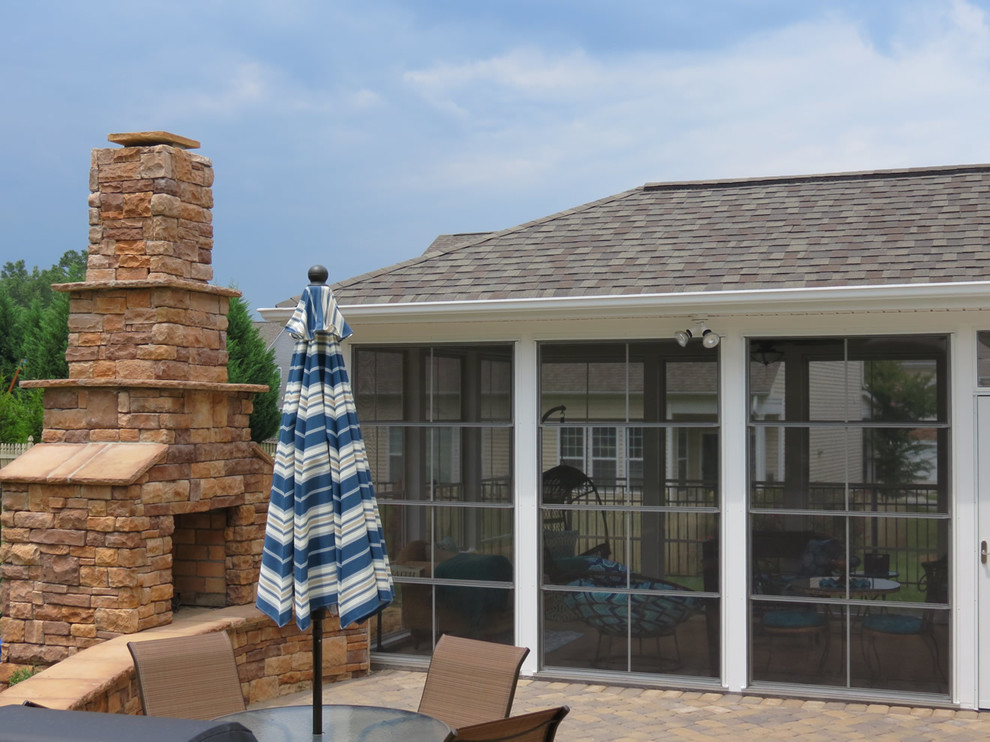 Mid-sized traditional backyard patio in Charlotte with a fire feature and brick pavers.