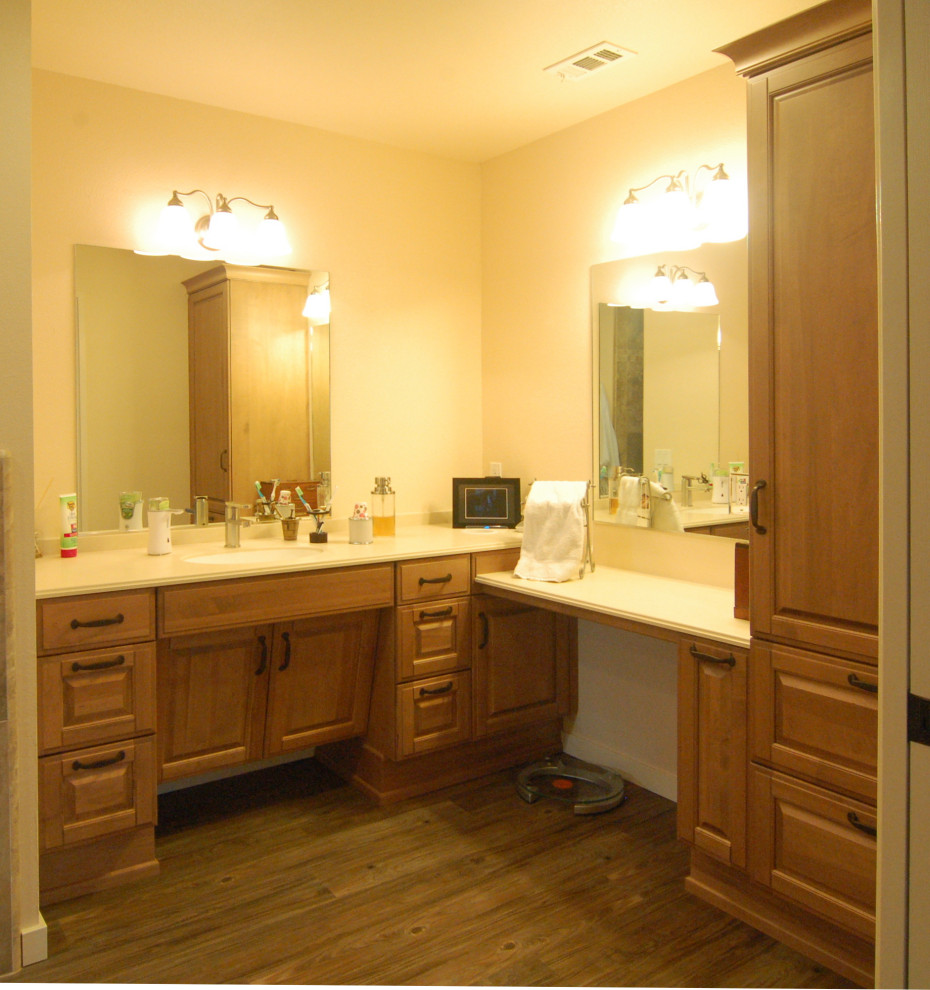This is an example of a mid-sized country bathroom in San Luis Obispo with raised-panel cabinets, solid surface benchtops, white benchtops, a single vanity and a built-in vanity.