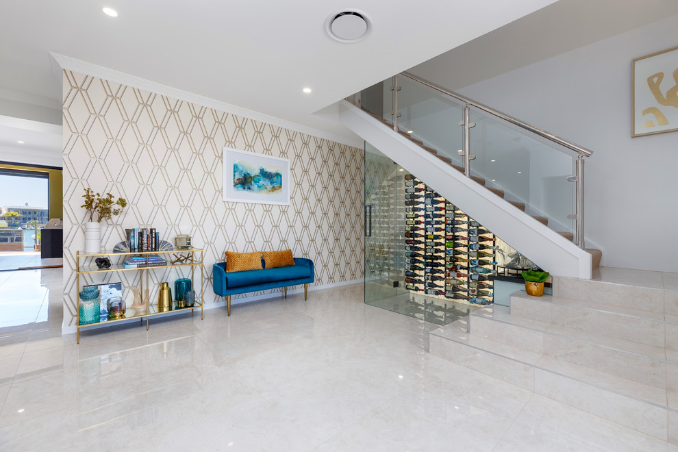 Photo of a contemporary wine cellar in Brisbane with display racks and beige floor.