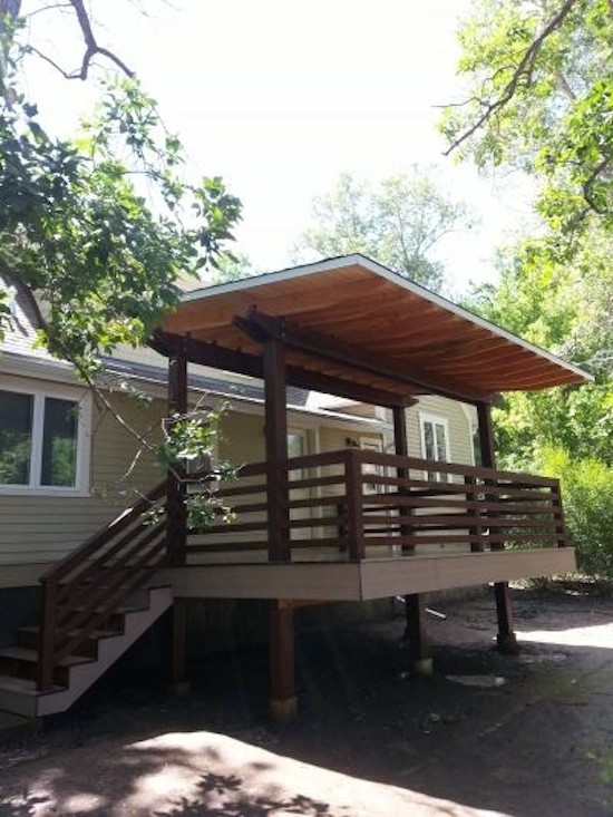 Mid-sized transitional side yard balcony deck photo in Denver with an awning