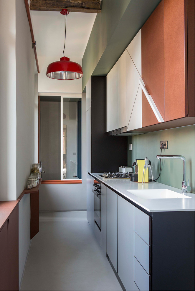 This is an example of a mid-sized midcentury single-wall separate kitchen in Turin with flat-panel cabinets, green splashback, no island, grey floor and white benchtop.