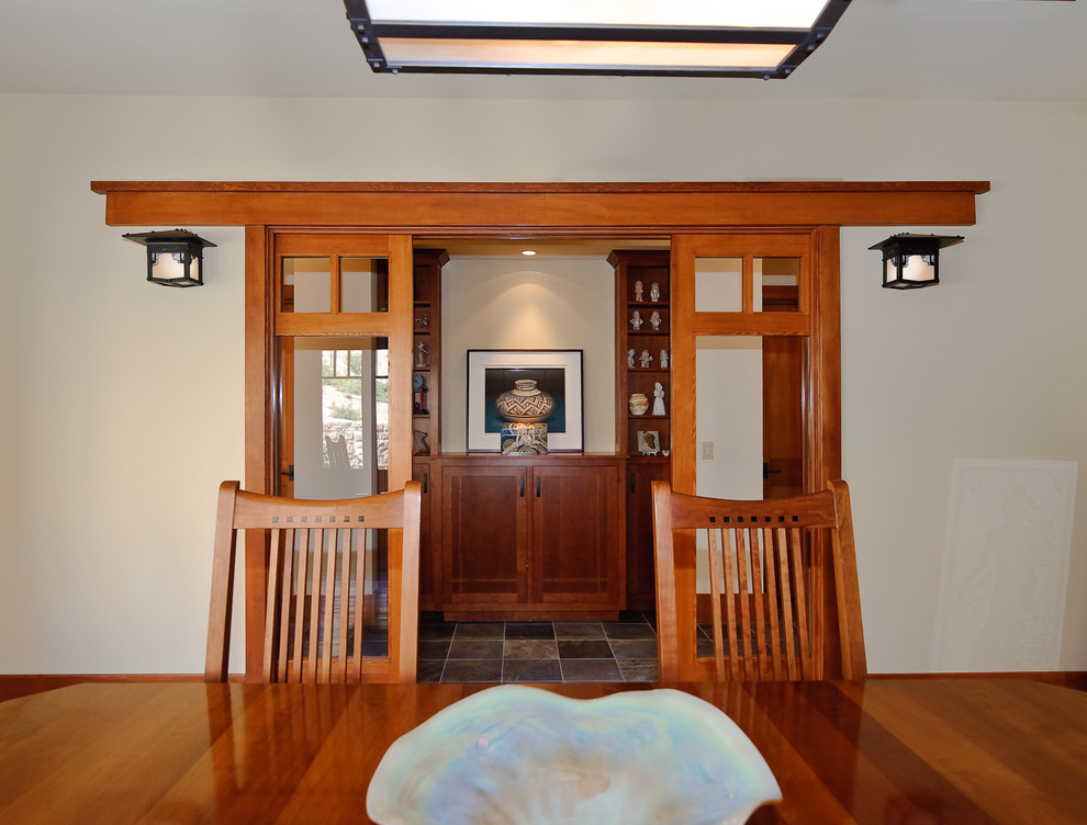 Photo of a large arts and crafts separate dining room in Orange County with no fireplace and grey walls.