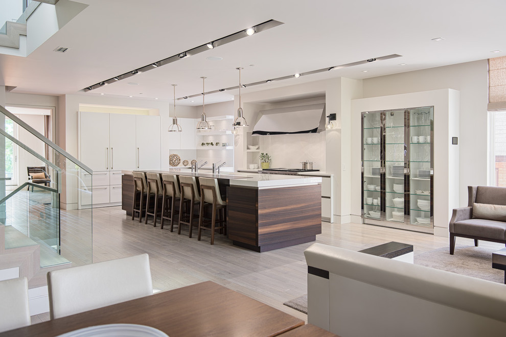 Photo of a contemporary galley open plan kitchen in Ottawa with flat-panel cabinets and white cabinets.
