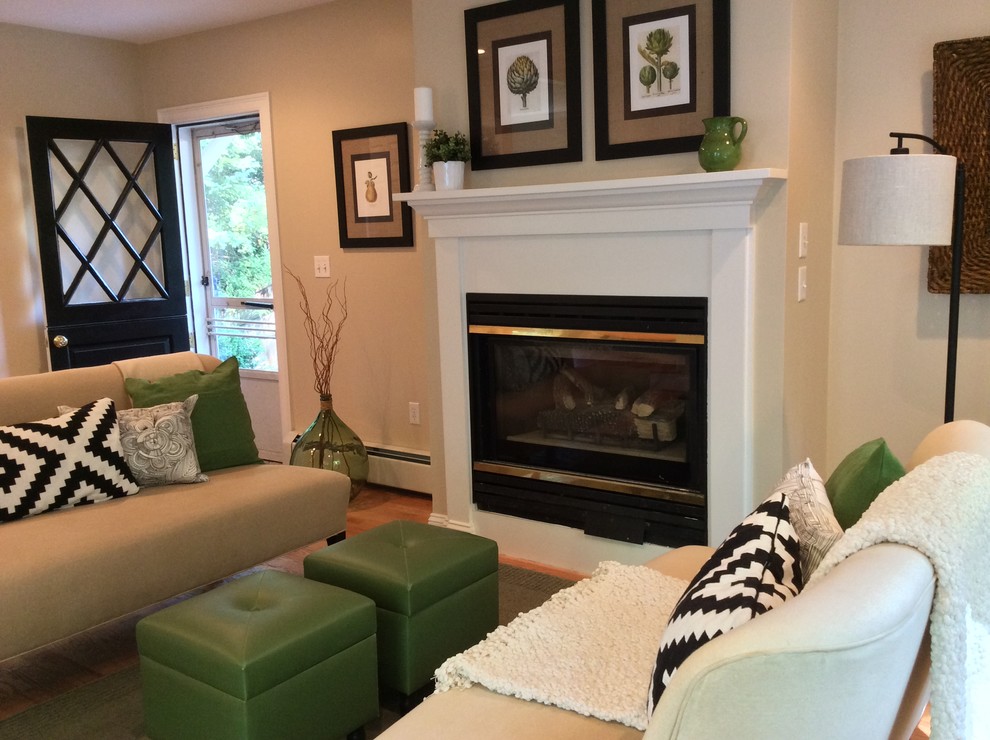 Small transitional enclosed family room in Boston with beige walls, light hardwood floors, a standard fireplace, a wood fireplace surround and no tv.