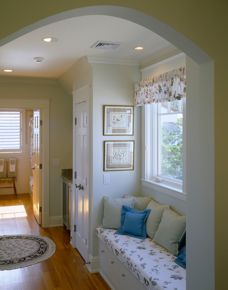 Photo of a mid-sized transitional hallway in Portland Maine with beige walls, medium hardwood floors and brown floor.