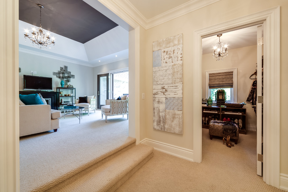 Photo of a large contemporary hallway in Toronto with beige walls, carpet and beige floor.