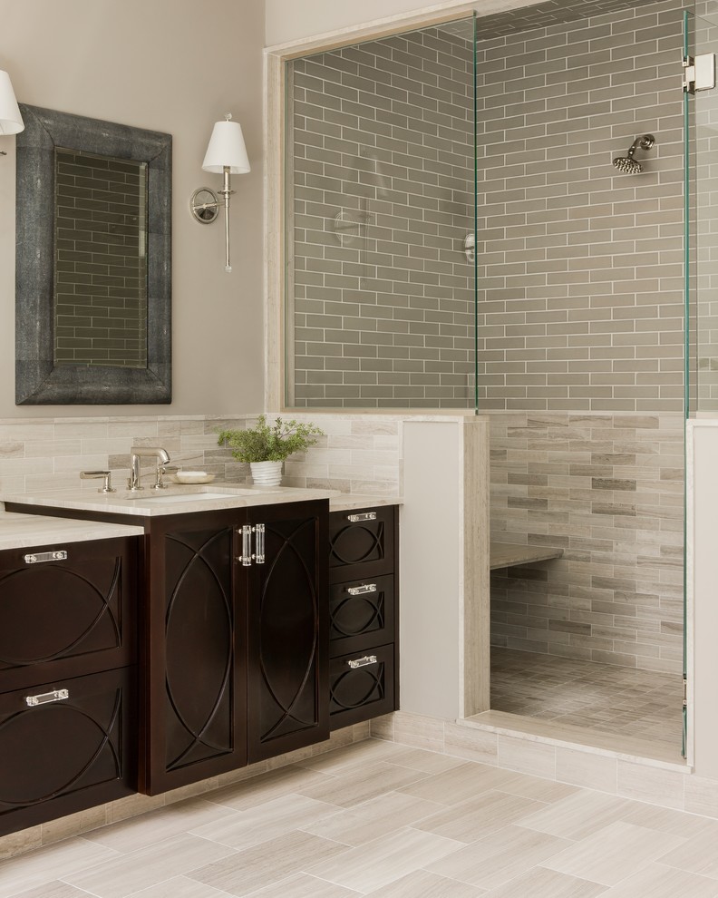 Photo of a mid-sized transitional 3/4 bathroom in Boston with dark wood cabinets, an alcove shower, beige tile, subway tile, beige walls, porcelain floors, an undermount sink, limestone benchtops, beige floor and an open shower.