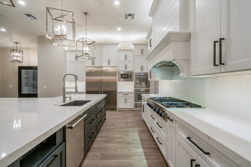 Example of a large minimalist u-shaped open concept kitchen design in Phoenix with an island
