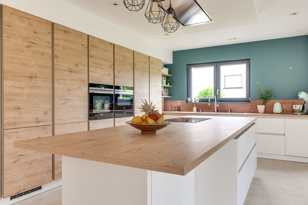 Photo of a contemporary l-shaped open plan kitchen in Strasbourg with a double-bowl sink, light wood cabinets, laminate benchtops, mosaic tile splashback, stainless steel appliances, concrete floors, with island and beige floor.