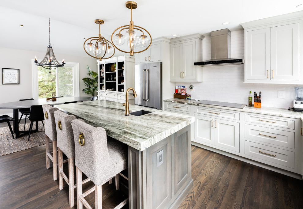 Design ideas for a mid-sized contemporary u-shaped eat-in kitchen in DC Metro with an undermount sink, shaker cabinets, white cabinets, white splashback, subway tile splashback, stainless steel appliances, dark hardwood floors, with island, brown floor and multi-coloured benchtop.