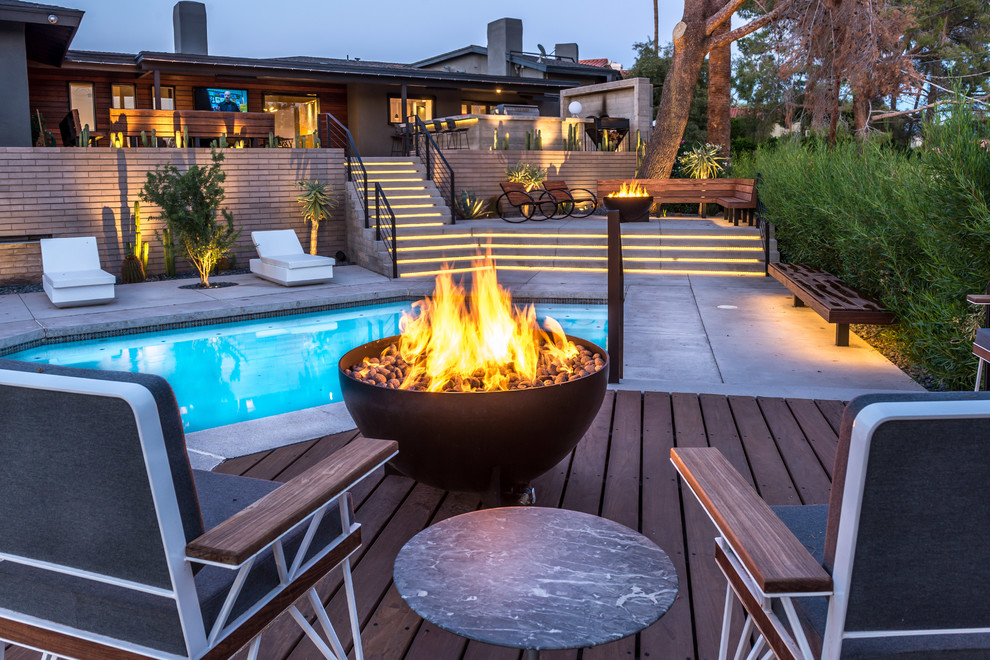 Huge transitional backyard concrete patio photo in Phoenix with a fire pit and no cover