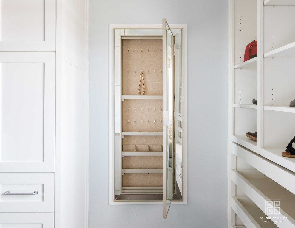 Inspiration for a large traditional walk-in wardrobe for women in Dallas with shaker cabinets, white cabinets, dark hardwood flooring and brown floors.