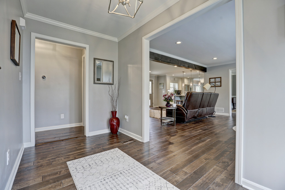 Photo of a mid-sized transitional foyer in Atlanta with grey walls, dark hardwood floors, a single front door, a gray front door and brown floor.