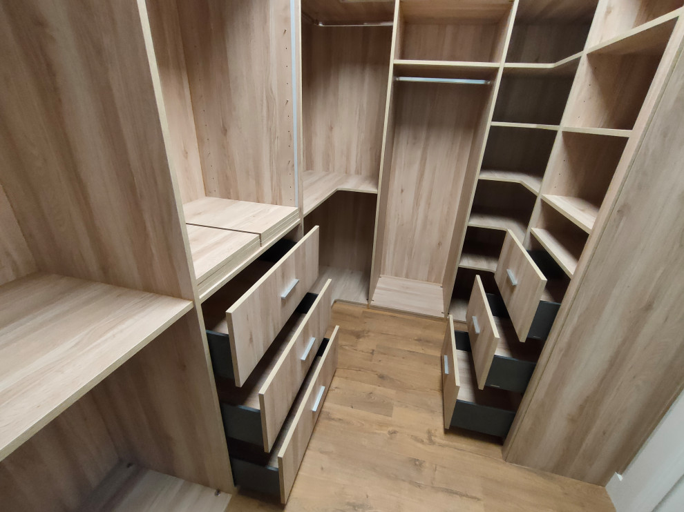 This is an example of a large transitional walk-in wardrobe in Other with open cabinets, medium wood cabinets, medium hardwood floors and brown floor.