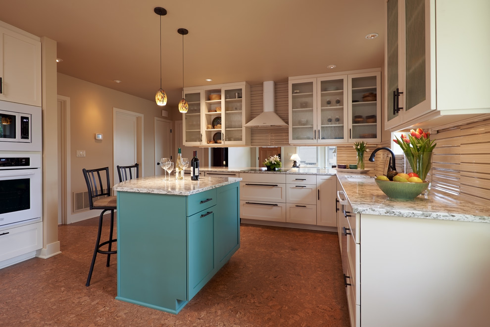Design ideas for a mid-sized arts and crafts l-shaped eat-in kitchen in Seattle with shaker cabinets, white cabinets, white appliances, cork floors, with island, quartzite benchtops, beige splashback, glass tile splashback, an undermount sink and brown floor.