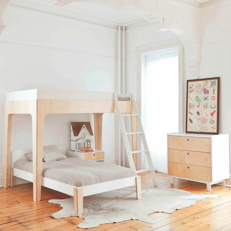 Photo of a large contemporary gender-neutral kids' bedroom for kids 4-10 years old in New York with white walls, light hardwood floors and brown floor.