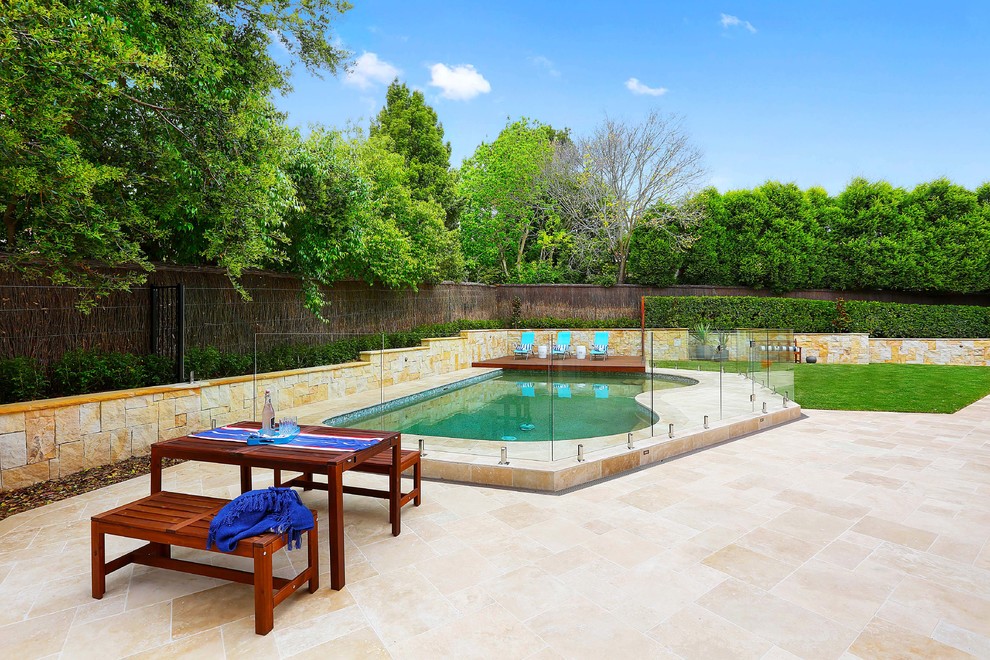 This is an example of a contemporary backyard custom-shaped pool in Sydney with tile.