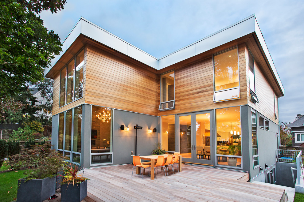 Design ideas for a contemporary two-storey exterior in Vancouver with wood siding and a flat roof.