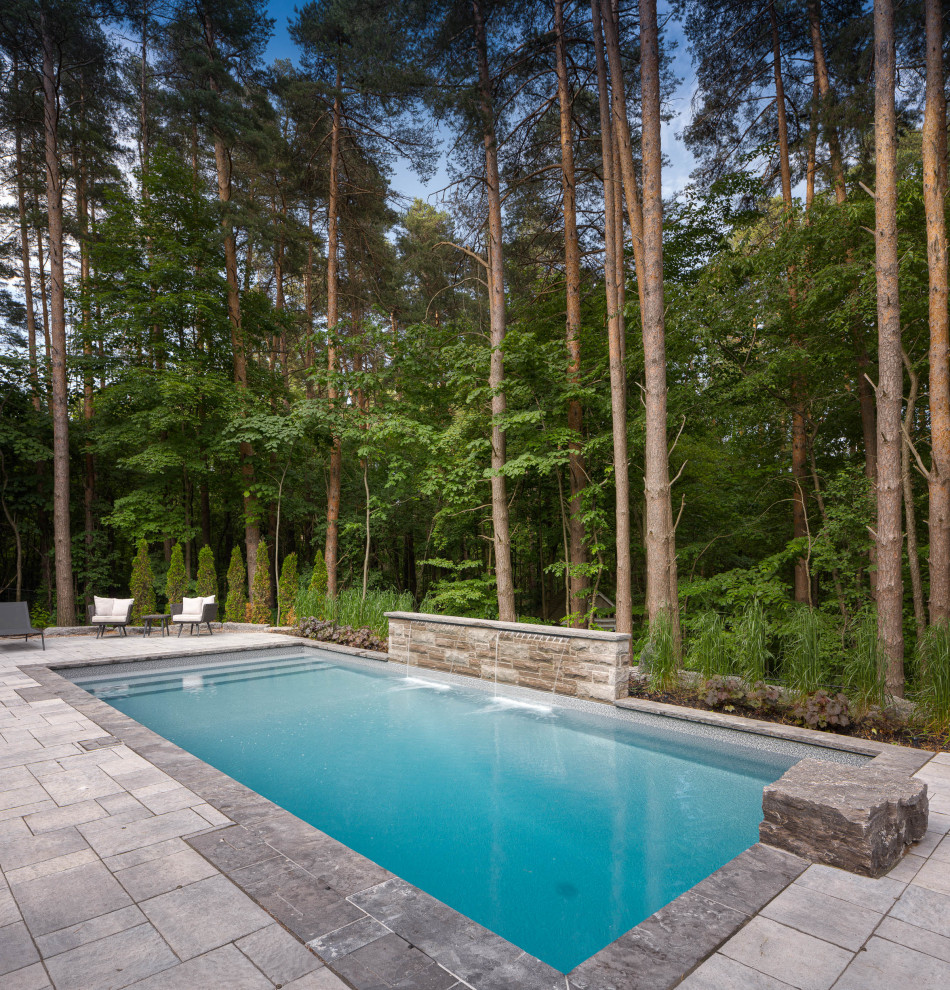 Example of a mountain style rectangular pool design in Toronto