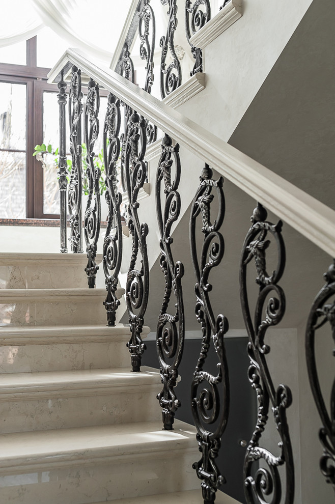 This is an example of a mid-sized traditional marble u-shaped staircase in Other with marble risers and mixed railing.