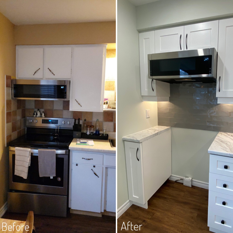 Mid-sized transitional galley vinyl floor eat-in kitchen photo in Toronto with a drop-in sink, shaker cabinets, white cabinets, laminate countertops, gray backsplash and stainless steel appliances
