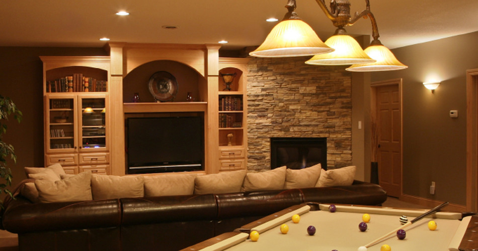 Example of a large trendy basement design in New York with brown walls, a standard fireplace and a stone fireplace