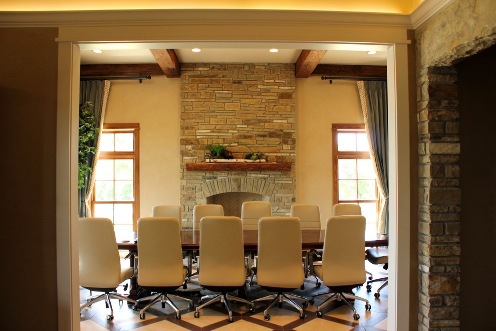 Mid-sized transitional dark wood floor home office photo with beige walls, a standard fireplace and a stone fireplace