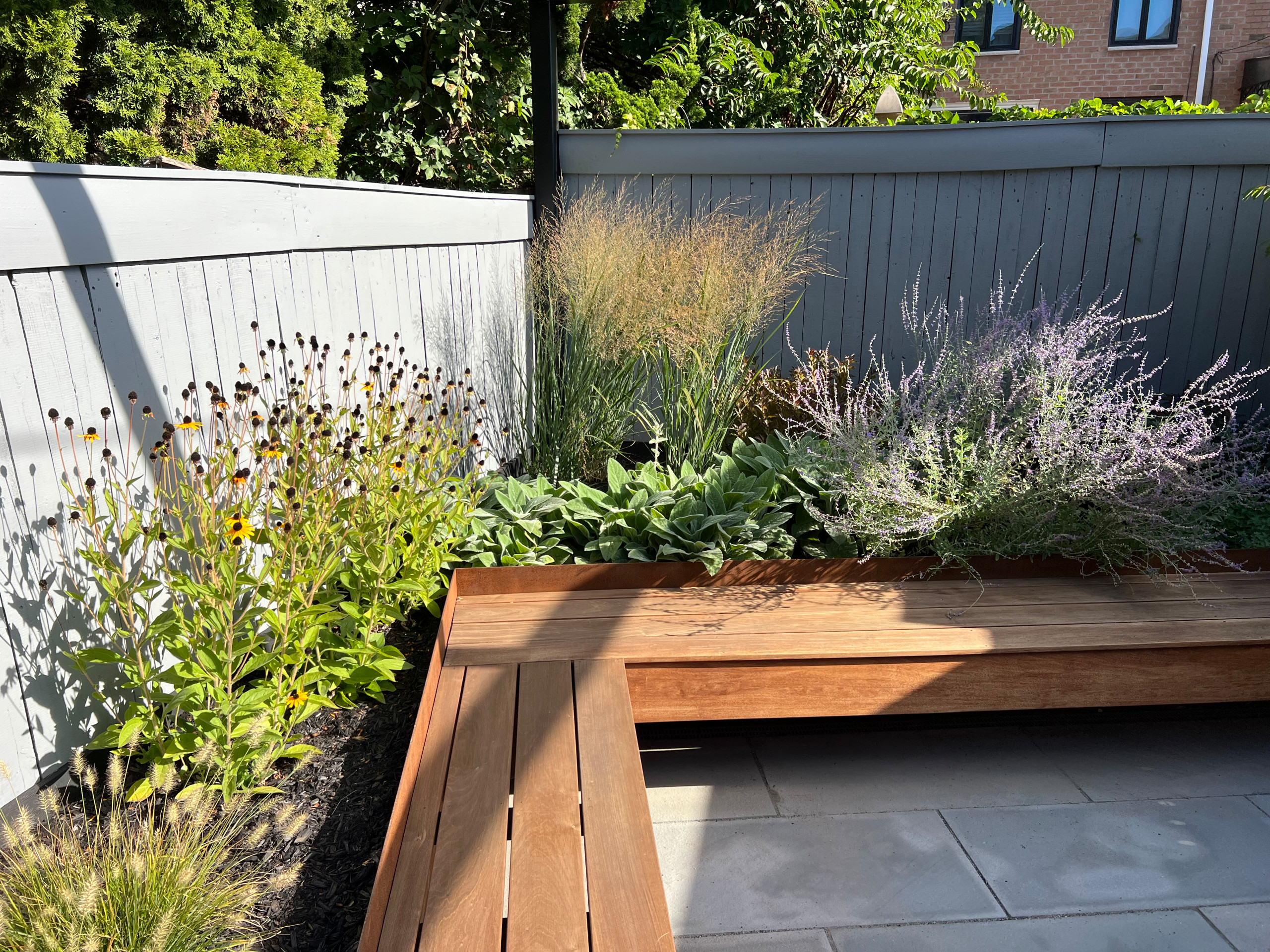 Paved patio with metal grating garden