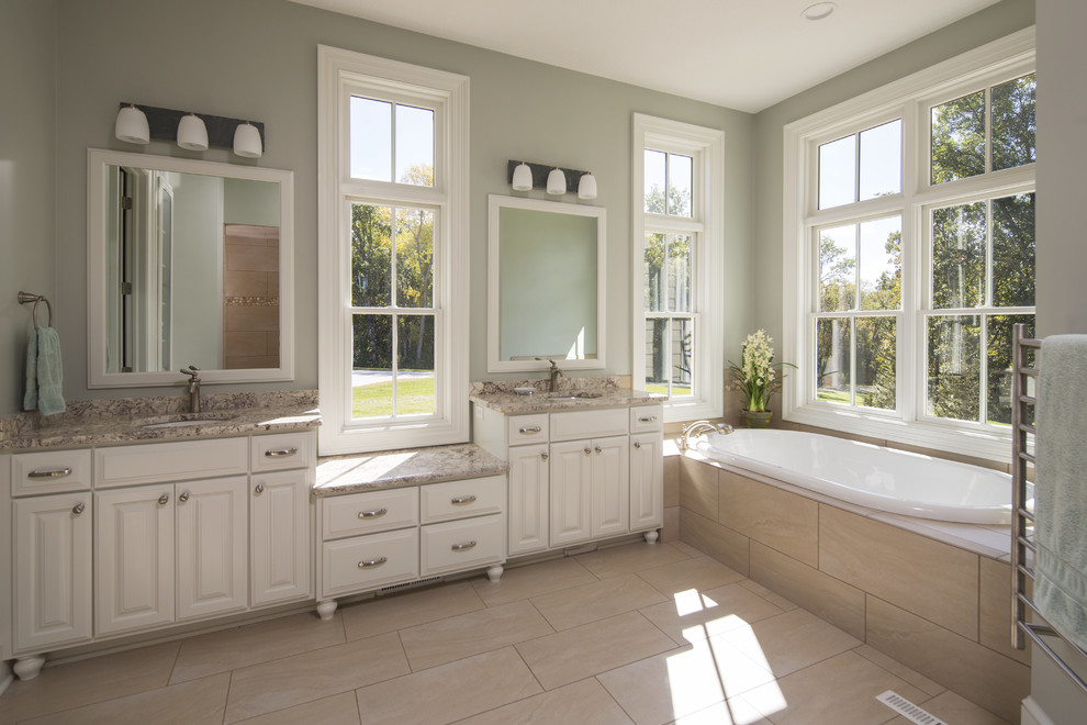 This is an example of a large traditional master bathroom in Other with an undermount sink, raised-panel cabinets, white cabinets, granite benchtops, a drop-in tub, an open shower, a two-piece toilet, beige tile, porcelain tile, blue walls and porcelain floors.