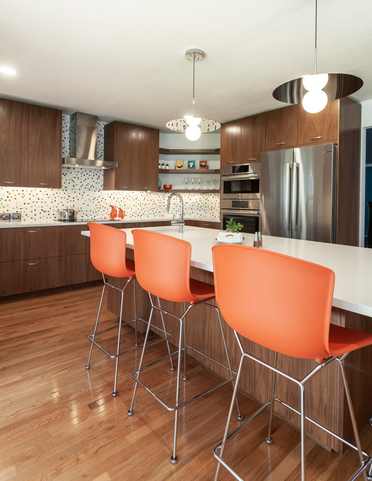 Design ideas for a large midcentury u-shaped eat-in kitchen in Detroit with an undermount sink, flat-panel cabinets, dark wood cabinets, quartz benchtops, multi-coloured splashback, ceramic splashback, stainless steel appliances, light hardwood floors, with island, brown floor and white benchtop.