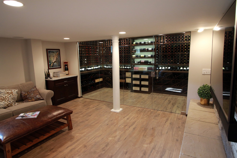 Design ideas for a mid-sized traditional wine cellar in Cincinnati with laminate floors, storage racks and brown floor.
