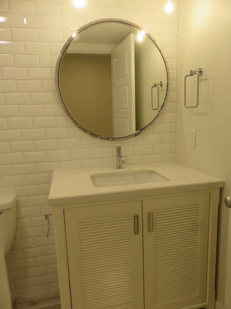 Small transitional kids' white tile and subway tile ceramic tile and gray floor alcove bathtub photo in Calgary with louvered cabinets, white cabinets, a two-piece toilet, white walls, an undermount sink and quartzite countertops