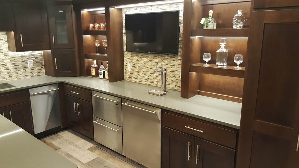 Inspiration for a mid-sized modern u-shaped home bar in Minneapolis with an undermount sink, shaker cabinets, dark wood cabinets, quartz benchtops, multi-coloured splashback, mosaic tile splashback and ceramic floors.
