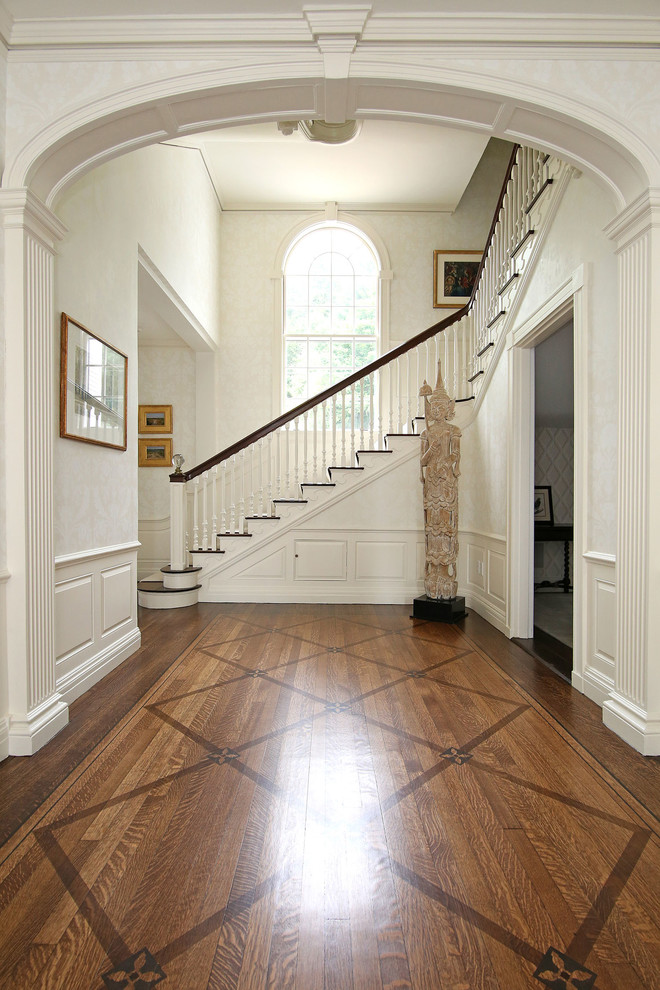 Traditional foyer in Boston with white walls and medium hardwood floors.