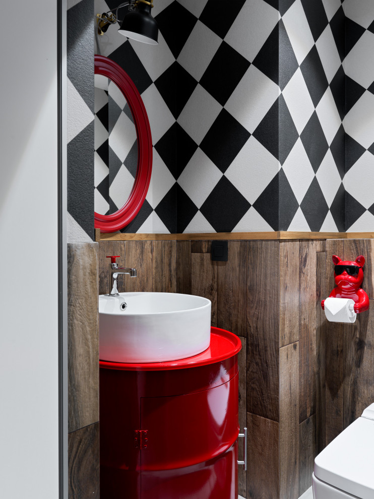 Photo of a small urban cloakroom in Moscow with flat-panel cabinets, red cabinets, a wall mounted toilet, brown tiles, porcelain tiles, brown walls, porcelain flooring, a built-in sink, zinc worktops, grey floors, red worktops, feature lighting, a freestanding vanity unit and wallpapered walls.