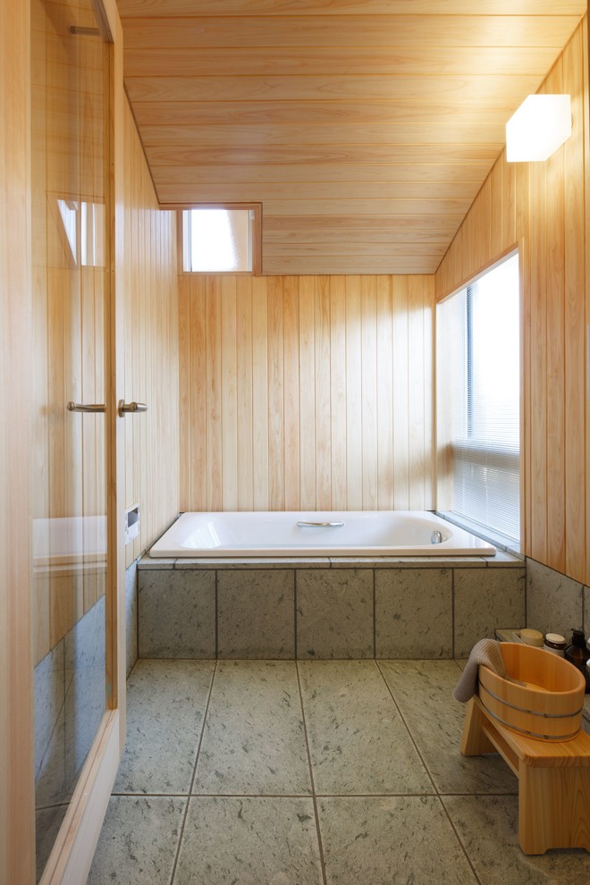 Photo of an asian master bathroom in Other with a drop-in tub and beige walls.